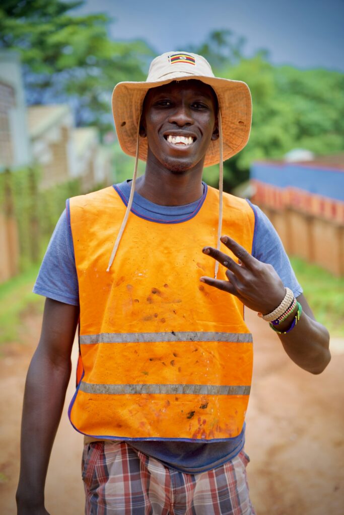 Smiling guide in an orange vest giving a peace sign