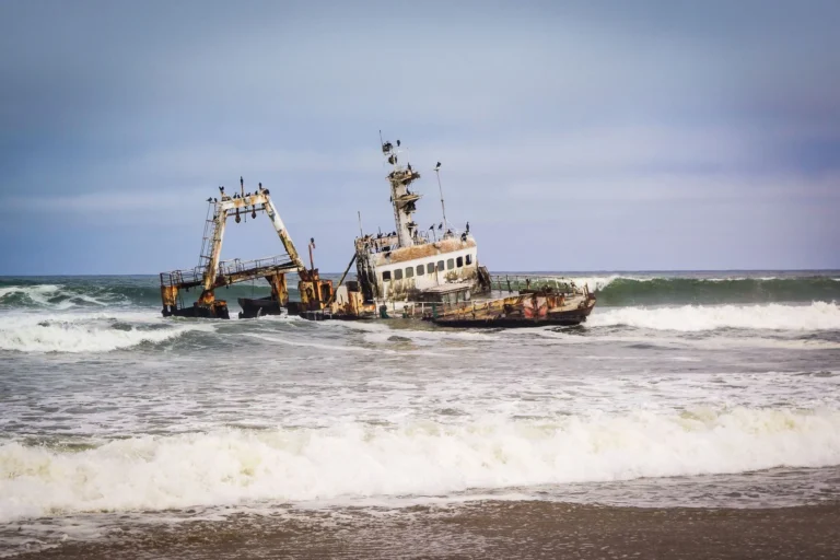 A rusty shipwreck on the coast at Swakopmund, Namibia