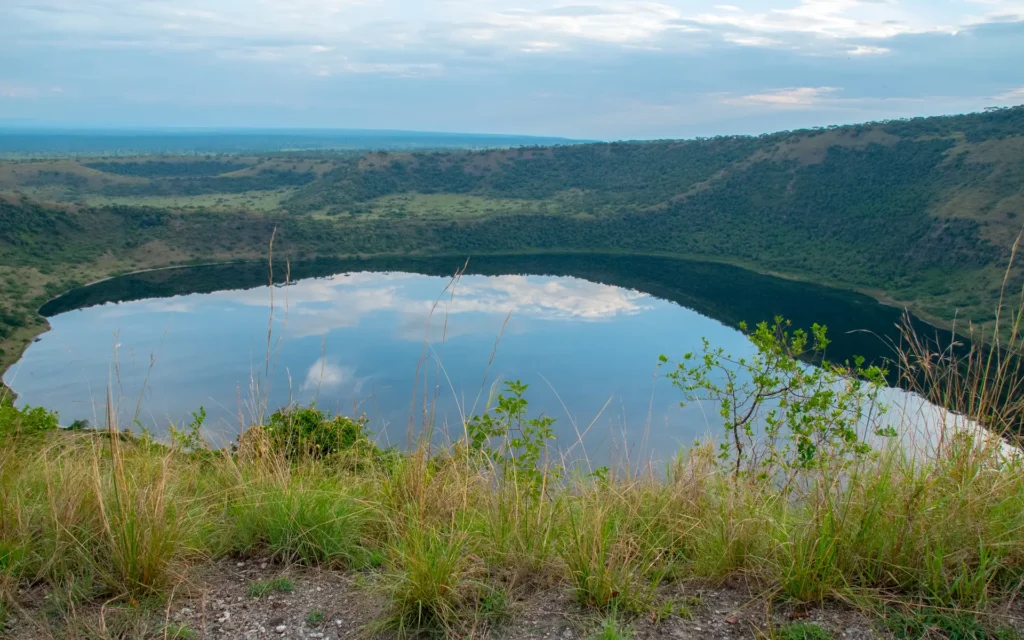 Crater lake reflecting clouds in Queen Elizabeth National Park